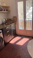 a kitchen with a door leading to a patio at Pied à terre Méditerranéen ! in Marseille