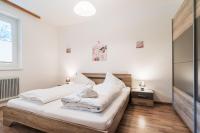 A bed or beds in a room at Appartementanlage Thermenblick SKI IN & SKI OUT