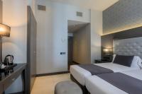 A bed or beds in a room at Hotel Ciutadella Barcelona