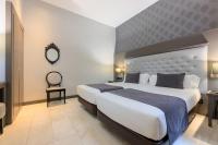 A bed or beds in a room at Hotel Ciutadella Barcelona