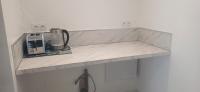 a marble counter top with a coffee maker on it at CHEZ LALLA in Marseille