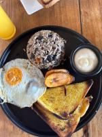 a plate of breakfast food with an egg and toast at Costa Rica Guesthouse in San José