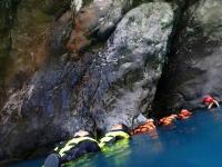 a group of people in the water in a cave at Taroko Susi Space in Xincheng
