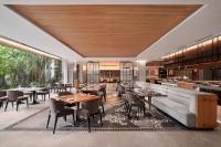 Un restaurante con mesas y sillas y un sofá. en Sheraton Hanoi West, en Hanói