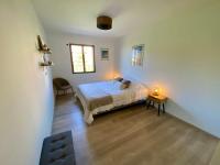 a bedroom with a bed and a table with two lights at Piana - vue mer et village in Piana