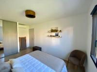 a bedroom with a bed and a chair at Piana - vue mer et village in Piana