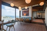 a dining room with a table and chairs and large windows at Best Western Premier Malta in St Paul's Bay