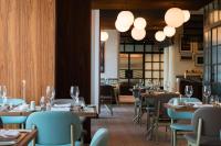 a dining room with tables and chairs and lights at Best Western Premier Malta in St Paul's Bay