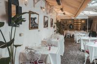 a dining room with white tables and chairs at Ada Palas Buyukada in Buyukada