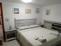 A bed or beds in a room at TITI' appartamento vacanze La Corte