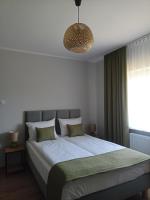 Łóżko lub łóżka w pokoju w obiekcie Flauta Apartamenty Rodzinne