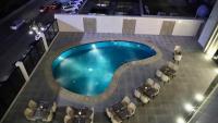 an overhead view of a swimming pool with tables and chairs at Five Seasons Hotel in Tabuk