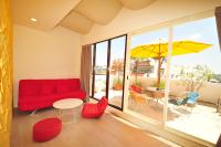 a living room with a red couch and a table and chairs at Little Sunshine in Dongshan