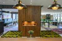 a lobby with green furniture and a dining room at CHATEAU R in Wettolsheim