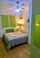 a bedroom with a bed with a ceiling fan at Le Passe-Port pour Marseille in Marseille