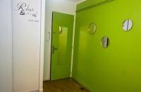 a green wall in a room with clocks on it at Le Passe-Port pour Marseille in Marseille