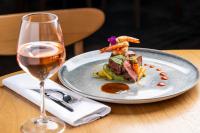 a plate of food next to a glass of wine at Hotel Alexandrion Experience in Sinaia