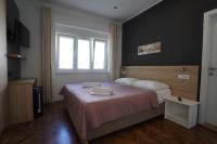 a bedroom with a bed with two towels on it at Rooms Villa Lucija in Kraljevica