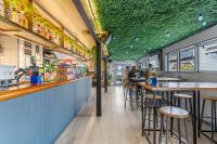 a restaurant with a green ceiling with bar stools at GY BOUTIQUE HOTEL in Glenorchy