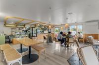 a group of people sitting at tables in a restaurant at GY BOUTIQUE HOTEL in Glenorchy