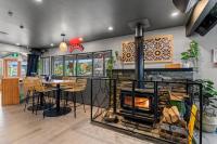 a kitchen with a fireplace and a table with chairs at GY BOUTIQUE HOTEL in Glenorchy
