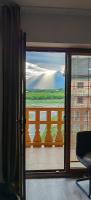 a door to a balcony with a view of a mountain at Apartment FIMM in Veľká Lomnica