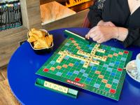 a board game on a table with a basket of bread at Best Western Plus Le Conquerant Rouen Nord in Bois-Guillaume
