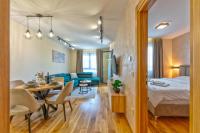 a hotel room with a bed and a dining room at Apartman Filipović, Vila Dunav in Zlatibor
