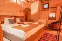Postel nebo postele na pokoji v ubytování Carmin Cave Hotel