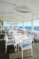 un groupe de tables et de chaises blanches sous un parapluie dans l'établissement Escape to Paradise, Deluxe Fractional 2BR Garden Pool Villa Private Beach Near Uluwatu, à Uluwatu