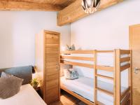 A bed or beds in a room at Tauern Lodge L