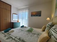 a bedroom with a large bed and a window at Apartment Danica in Malinska