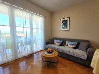 a living room with a couch and a table at Apartment Danica in Malinska