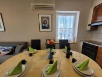 a dining room table with green napkins and glasses at Apartment Danica in Malinska