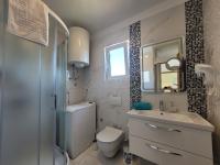 a bathroom with a toilet and a sink and a mirror at Apartment Danica in Malinska