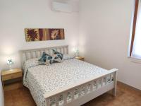 A bed or beds in a room at Pavoncelle Holidays Home
