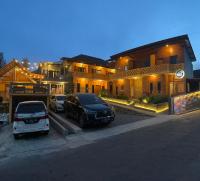 a couple of cars parked in front of a building at Homestay Lereng Bromo in Bromo