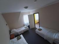 a hotel room with two beds and a doorway at AMRI Apartman in Balatonföldvár