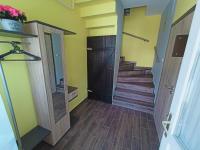 a hallway with a door and stairs in a house at AMRI Apartman in Balatonföldvár