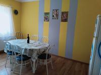 a dining room with a table and chairs and yellow walls at AMRI Apartman in Balatonföldvár