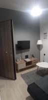 Televízia a/alebo spoločenská miestnosť v ubytovaní Eva apartment