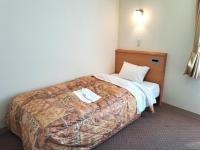 a hotel room with a bed with a blanket at Hotel Tetora Higashimuroran - Vacation STAY 75819v in Muroran