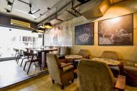 a restaurant with chairs and tables and a bar at Naivara Boutique Hotel in Udaipur