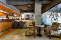 a restaurant with chairs and a table and a counter at Naivara Boutique Hotel in Udaipur