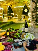 a table topped with plates of food and wine glasses at Sun Valley Homestay Bảo Lộc in Bao Loc