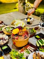 a table topped with lots of different types of food at Sun Valley Homestay Bảo Lộc in Bao Loc