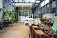 a patio with a table and chairs and plants at Antlers Guest House in Taitung City