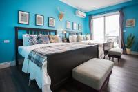 a bedroom with blue walls and a large bed at Antlers Guest House in Taitung City