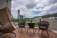 a patio with chairs and a table on a balcony at Antlers Guest House in Taitung City