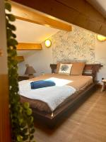 a bedroom with a large bed with a wooden frame at Maison piscine &amp; spa Vallon Pont d&#39;Arc in Vallon-Pont-dʼArc
